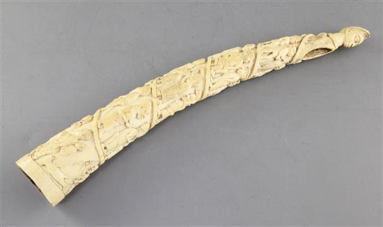 A Belgian Congo ivory oliphant, c.1900, carved with a procession of figures, hammerhead shark fishermen and 41cm